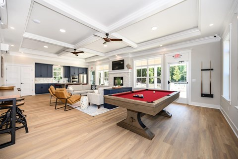 A pool table is in the middle of a room with a ceiling fan at The Promenade at Easton Apartments, Easton, MD 21601