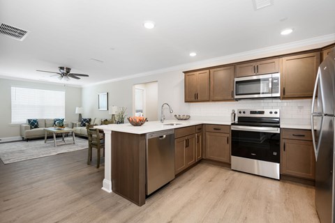 A modern kitchen with wooden cabinets and stainless steel appliances.