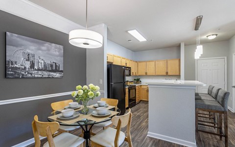 a dining room and kitchen with a table and chairs