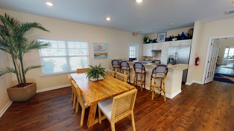 A dining room with a wooden table and chairs.