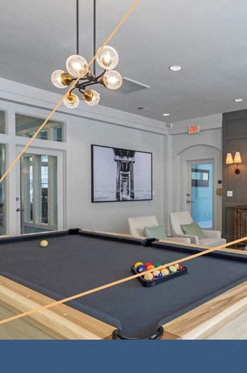 a pool table in a living room with a lamp at Breakers Point, South Carolina, 29579