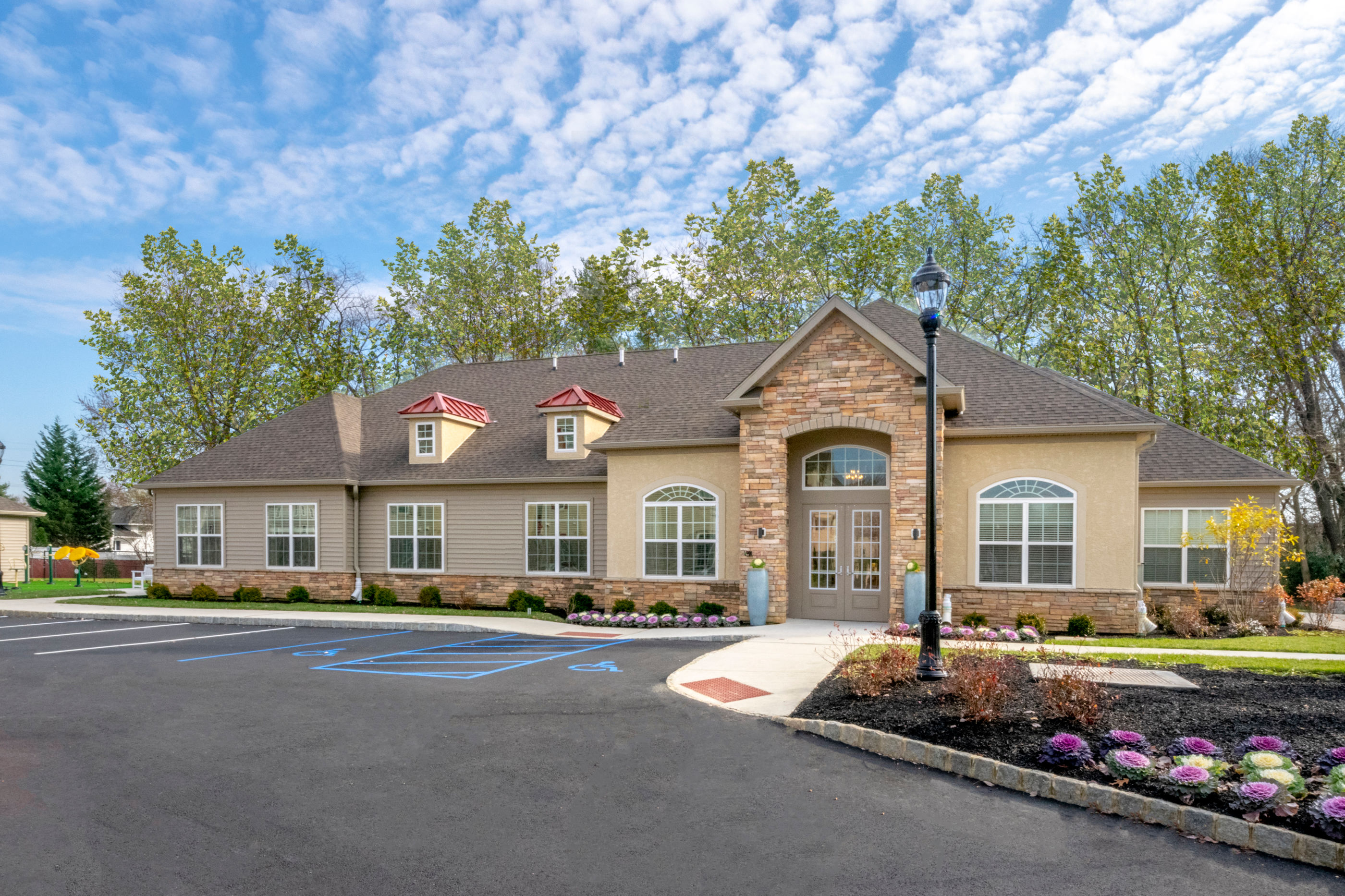 the exterior of a house with a driveway and a parking lot