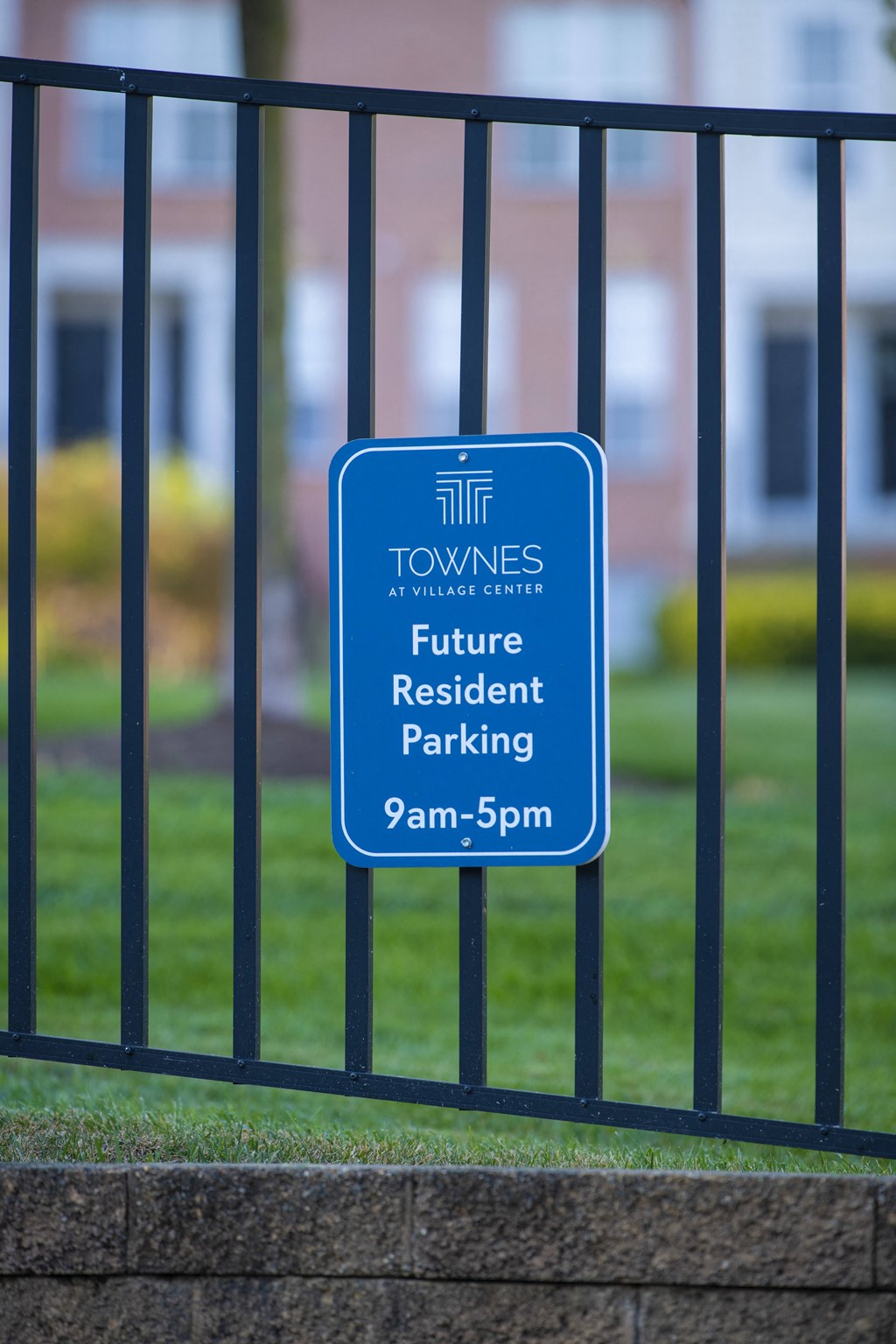 a blue parking sign at Townes at Village Center Apartments, Reisterstown, MD, 21136