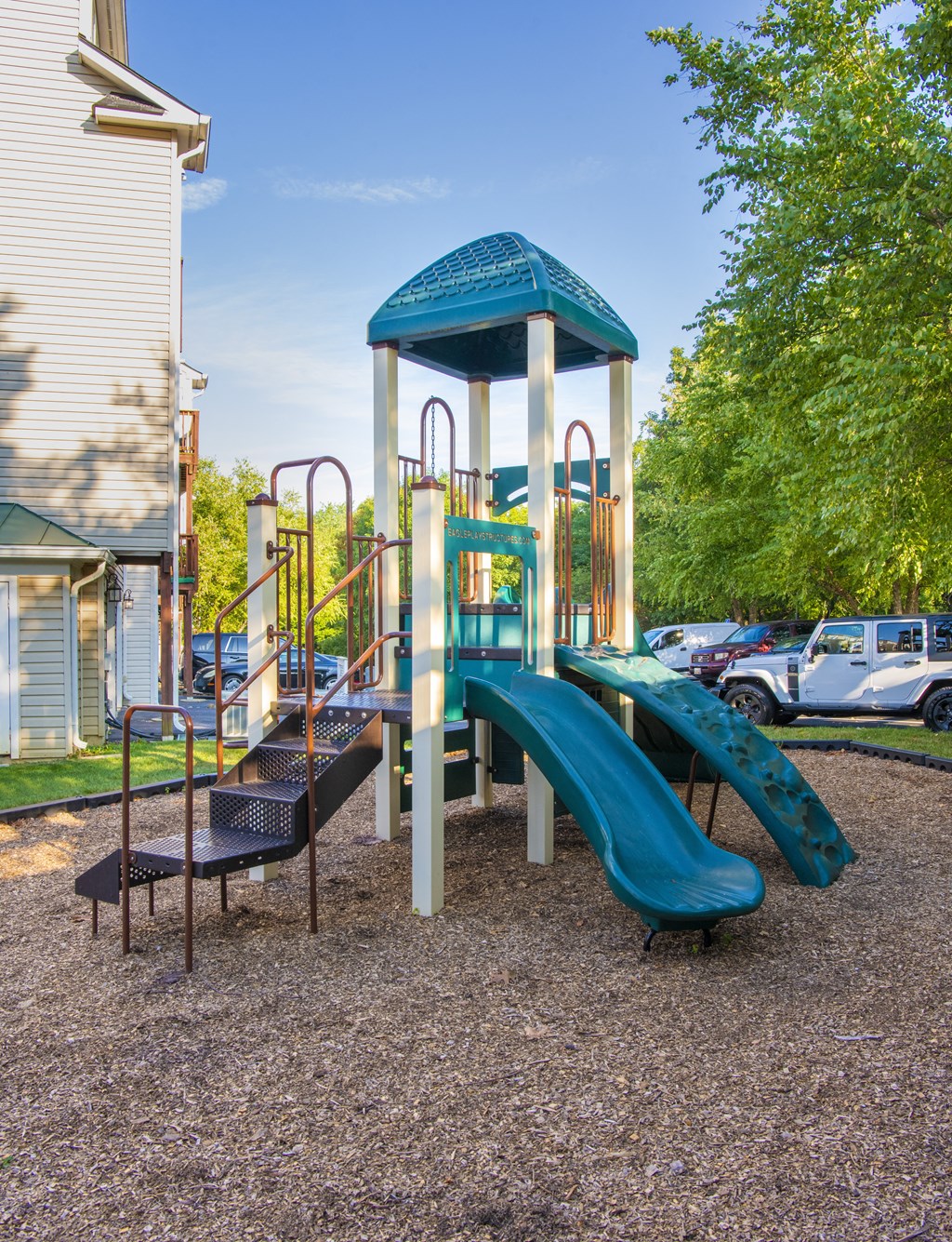 Playground with slides and a climb up at Townes at Village Center Apartments, Reisterstown