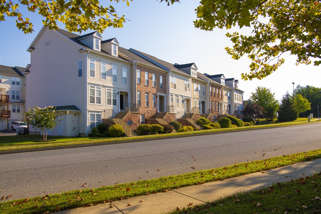 a row of houses on the side of a street at Townes at Village Center Apartments, Reisterstown, Maryland