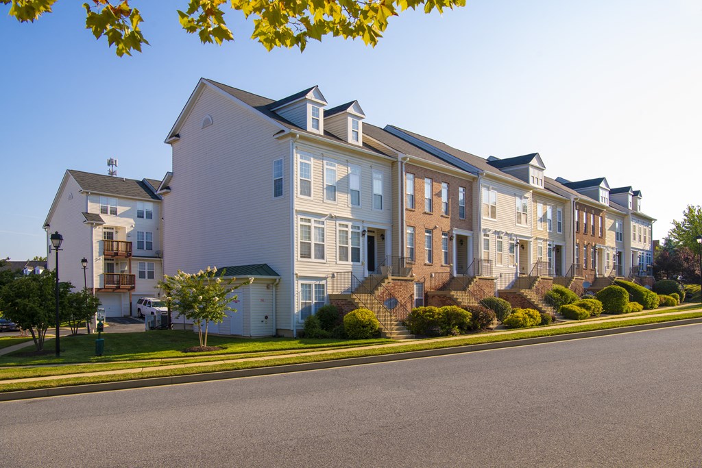 a row of houses on the side of a street at Townes at Village Center Apartments, Maryland