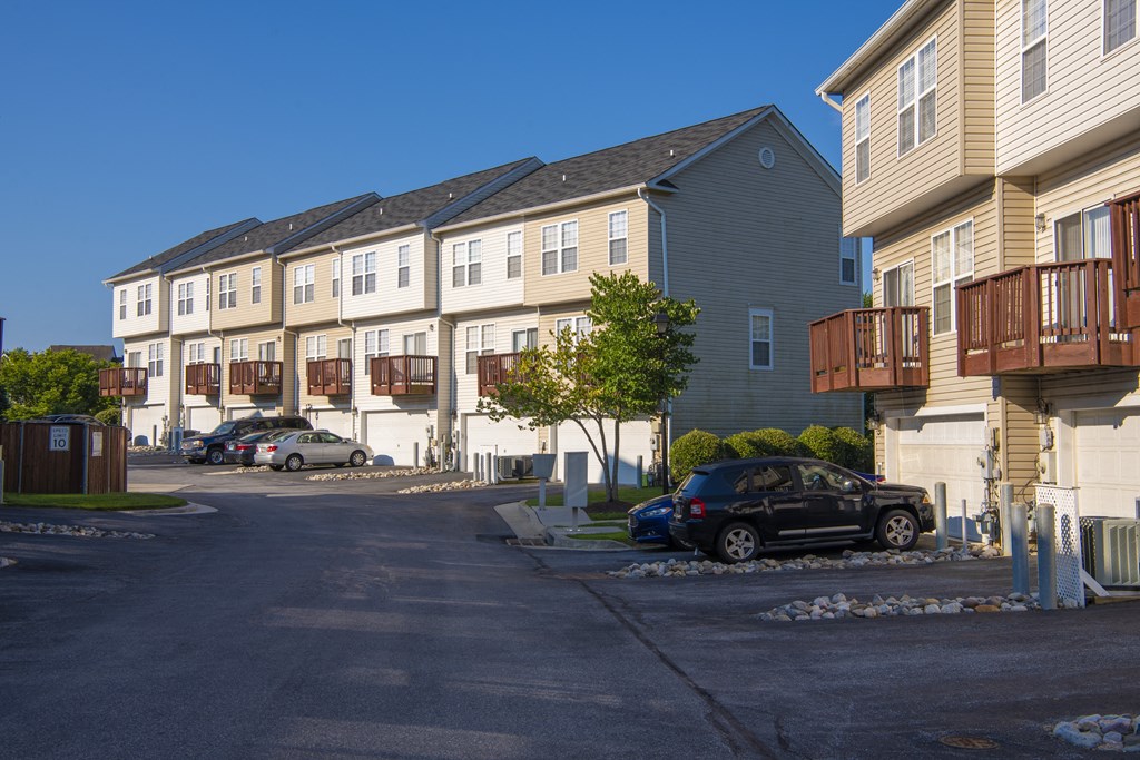 a row of houses on the side of a street at Townes at Village Center Apartments, Reisterstown, Maryland