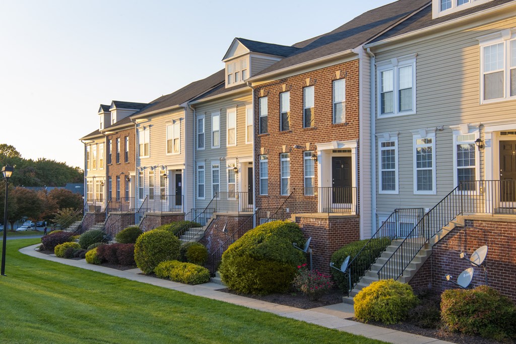 Building exterior with garden at Townes at Village Center, Reisterstown, 21136