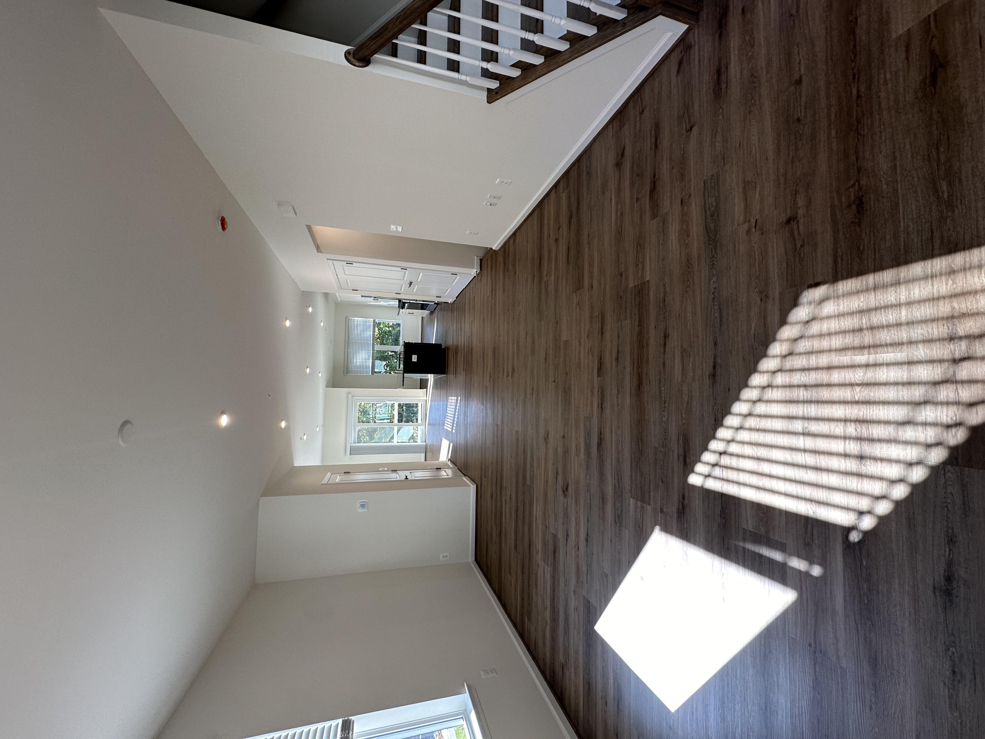 A room with wooden walls and a window with blinds.