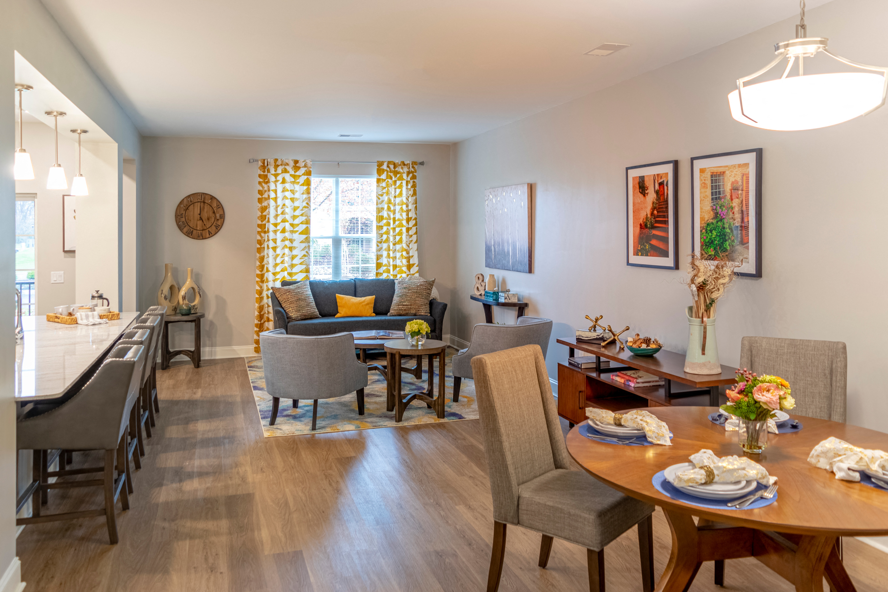 a living room and dining room with a table and chairs