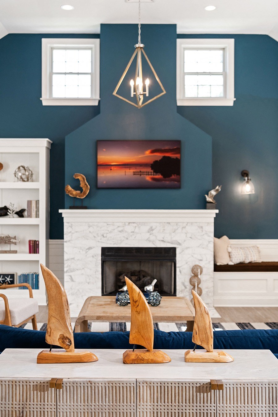 A living room with a fireplace and a painting above it. at Spa Cove Apartments, Annapolis, 21403