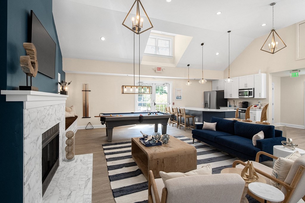 A living room with a pool table and a fireplace. at Spa Cove Apartments, Annapolis, 21403