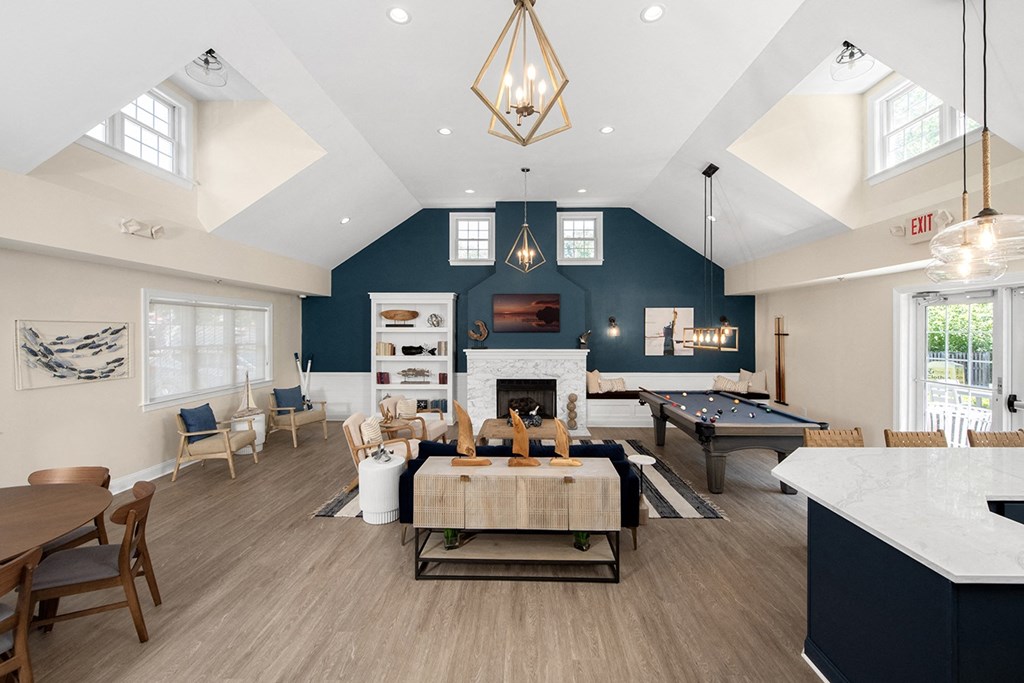 A large open living room with a fireplace and a pool table. at Spa Cove Apartments, Annapolis, 21403