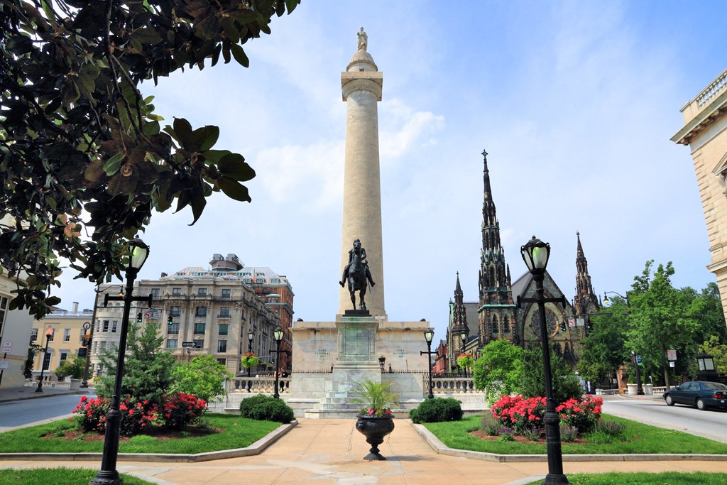 a tall column with a statue in the middle of a city street at Queen Anne Belvedere, Baltimore, 21201