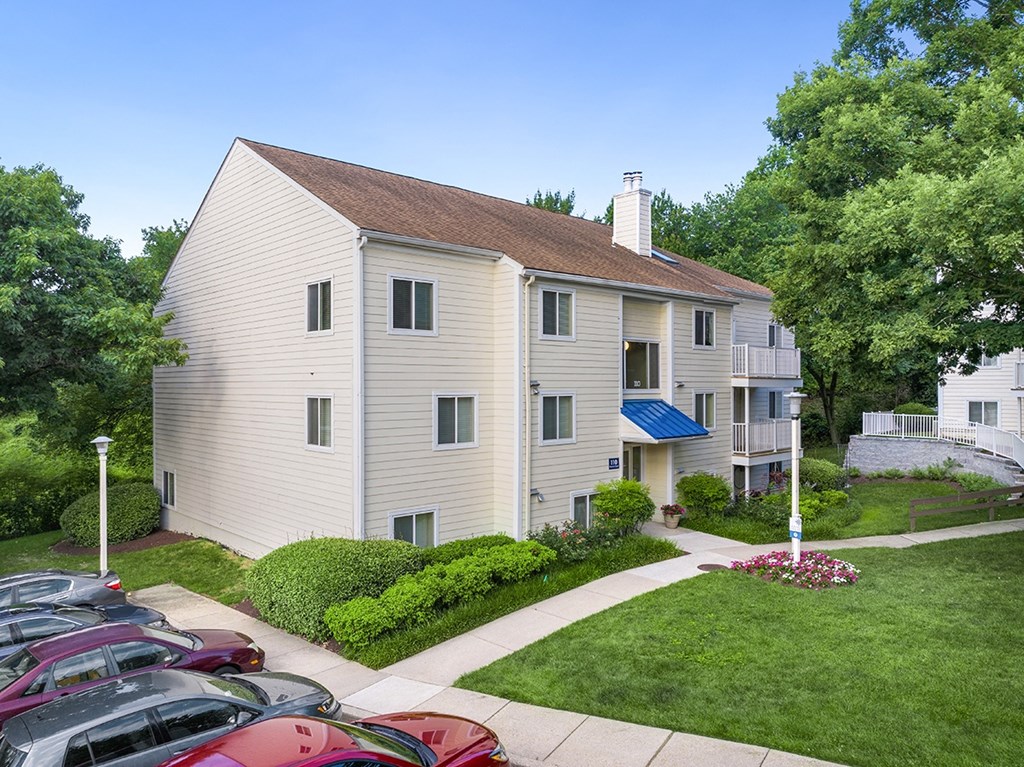 A two-story house with a blue awning and a parking lot in front. at West Woods, Maryland, 21401