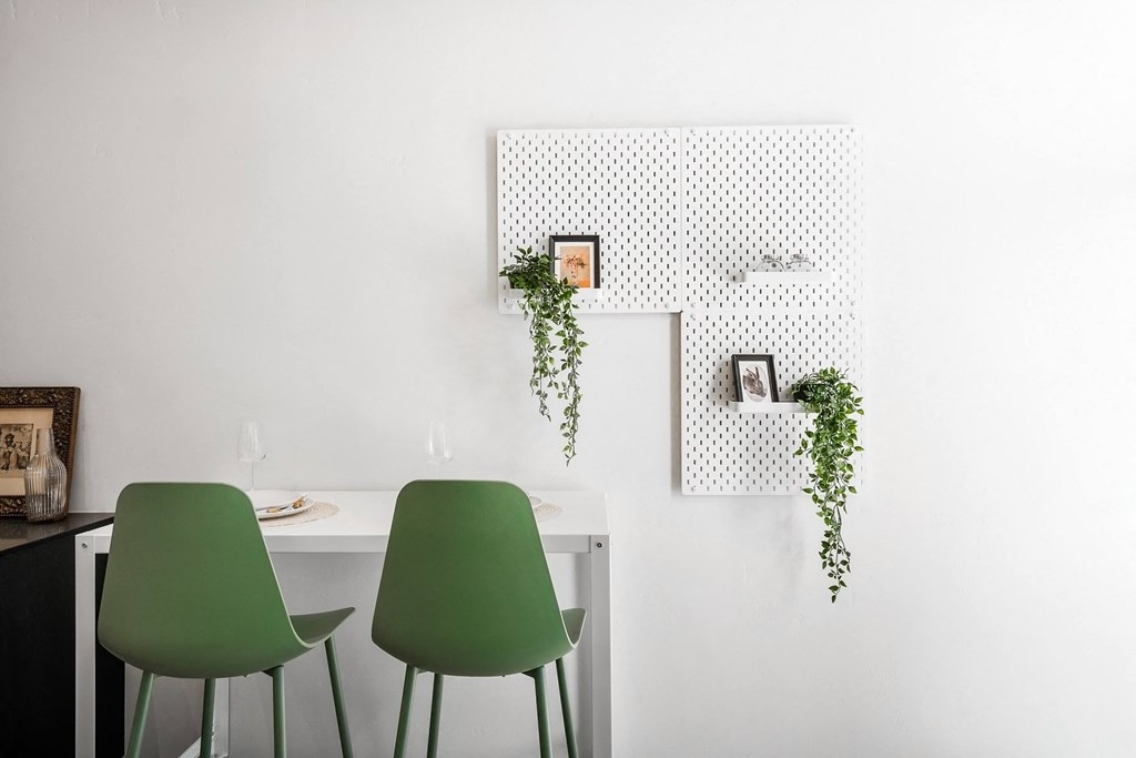 a room with green chairs and a white table