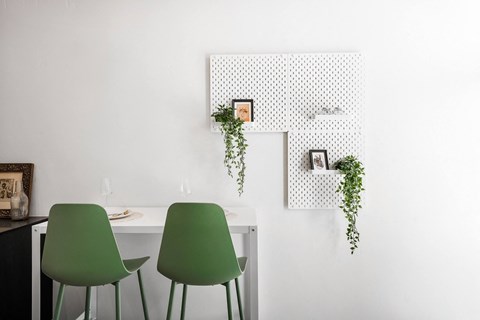 a room with green chairs and a white table