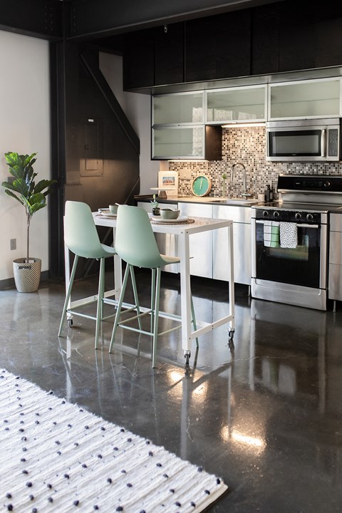a kitchen with a table and chairs and a stove