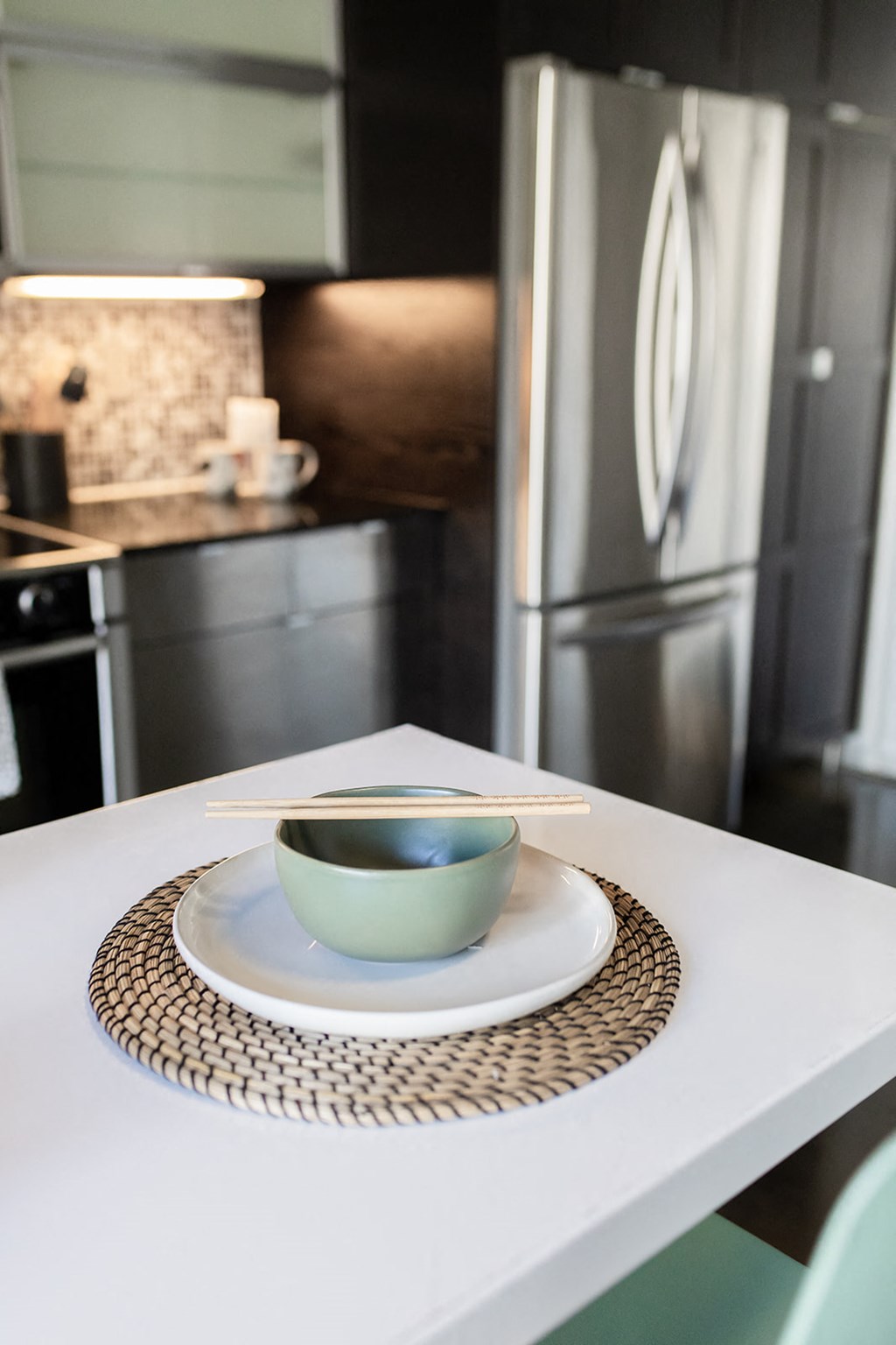 a white kitchen table with a blue bowl on top of it