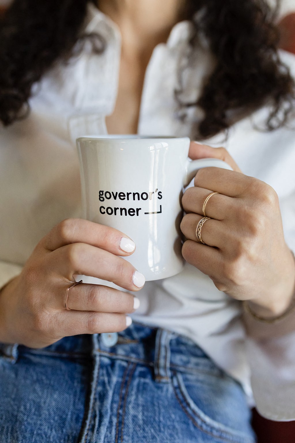 a woman holding a cup of coffee