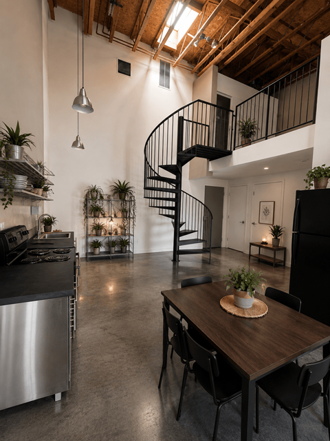 A modern kitchen with a stainless steel refrigerator and a wooden dining table.