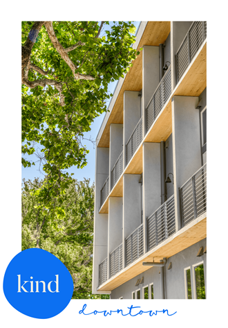 a picture of an apartment building with a blue circle with the word kind written on it