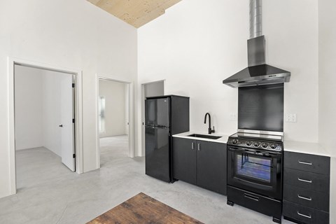 a kitchen with black appliances and a stove and refrigerator