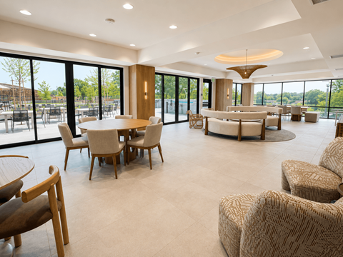 A spacious room with a table and chairs.