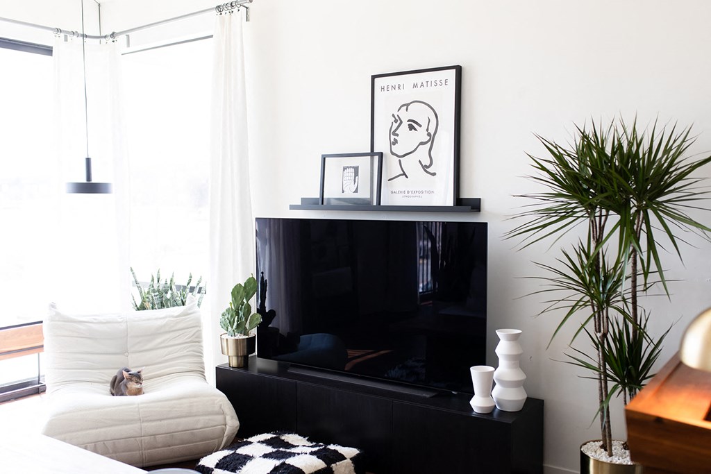 a living room with a black tv and a white couch