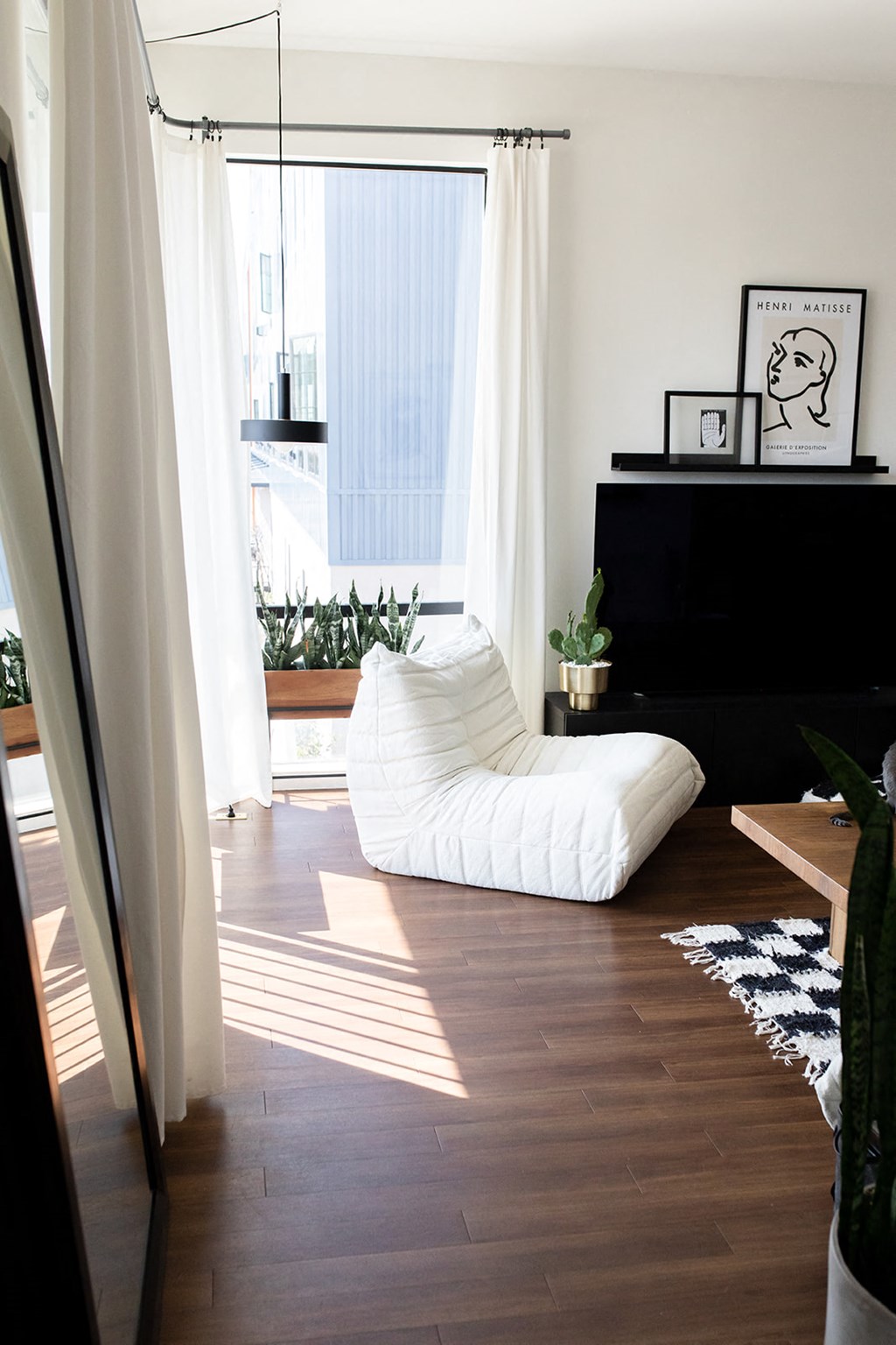 a living room with a bean bag chair and a television