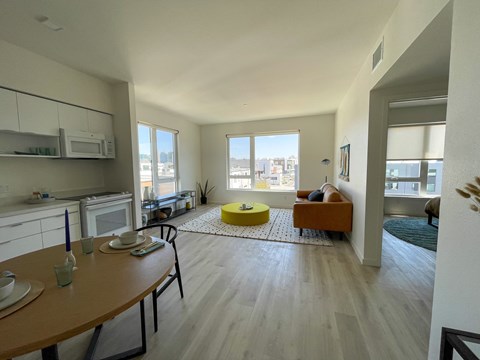 a view of a living room with a kitchen and a dining room