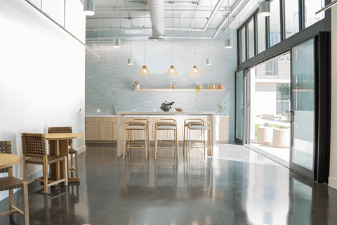 A modern dining area with wooden chairs and tables.