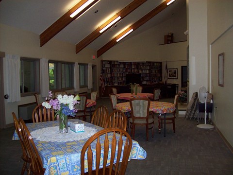 A dining room with a table set for a meal.