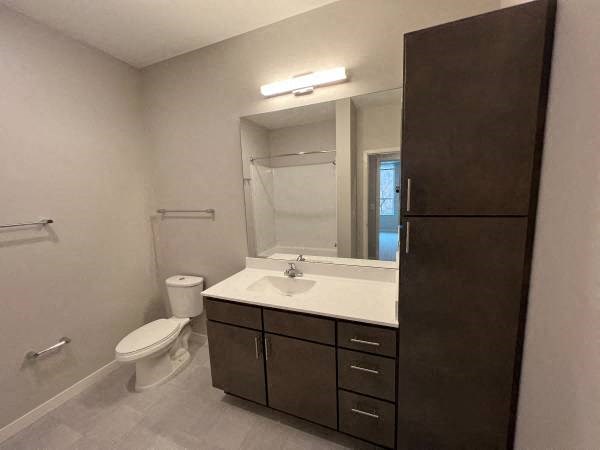 a bathroom with a toilet and a sink and a mirror