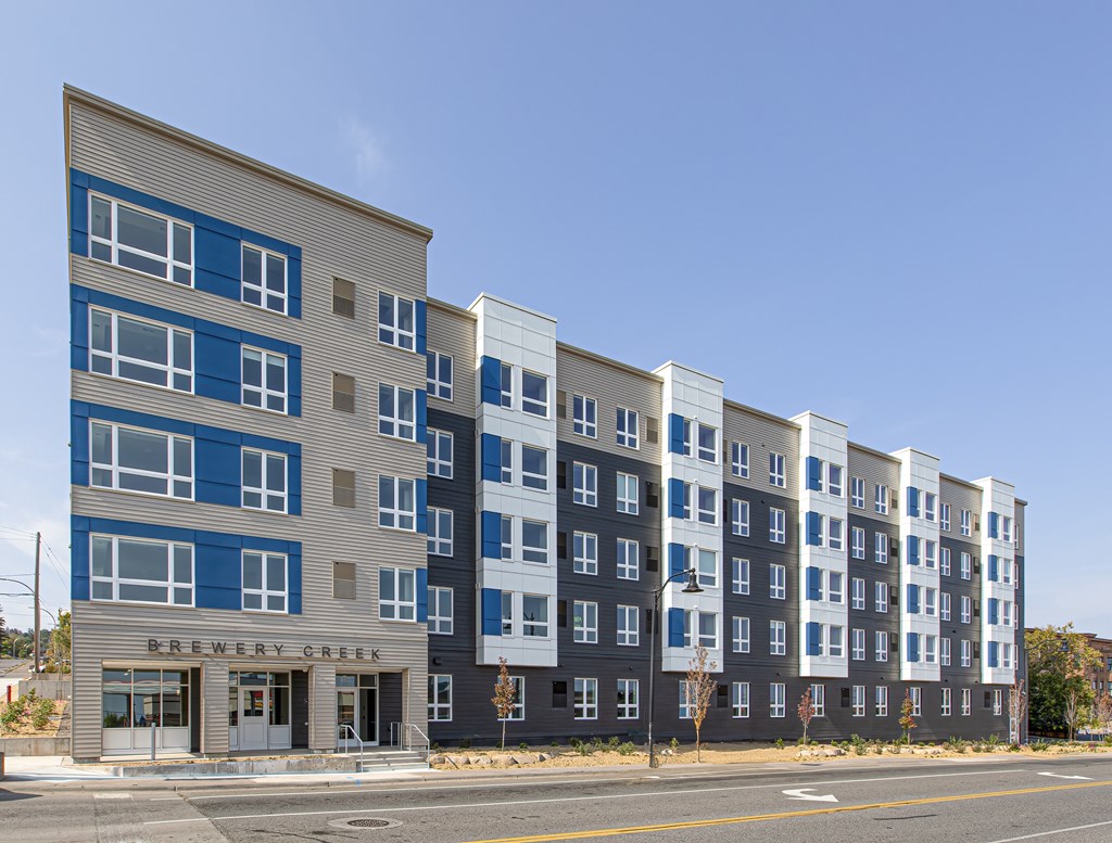A multi-story building with the name Brewery Creek on the front.