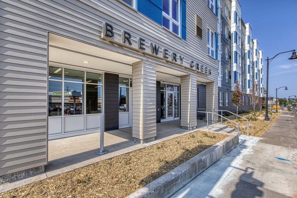 A building with a sign that says Brewery Green.
