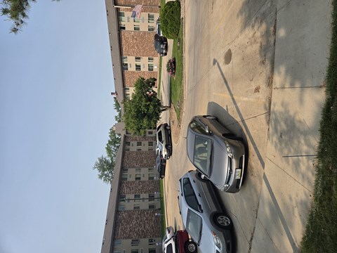 A car is parked on a street in front of a building.