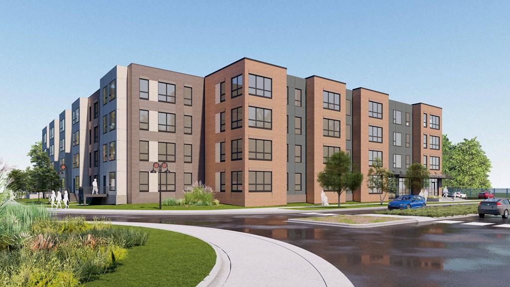 A modern apartment complex with a curved driveway in front.