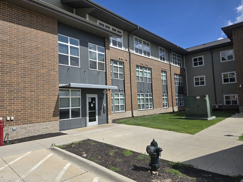 A fire hydrant is in front of a building.