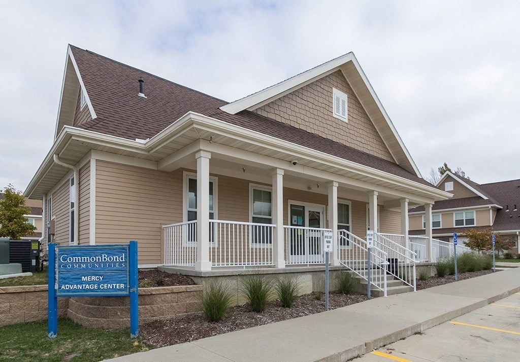 A house with a sign that says "CommonBond MERCY ADVANTAGE CENTER".