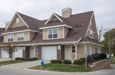 A house with a brown roof and a white garage door.