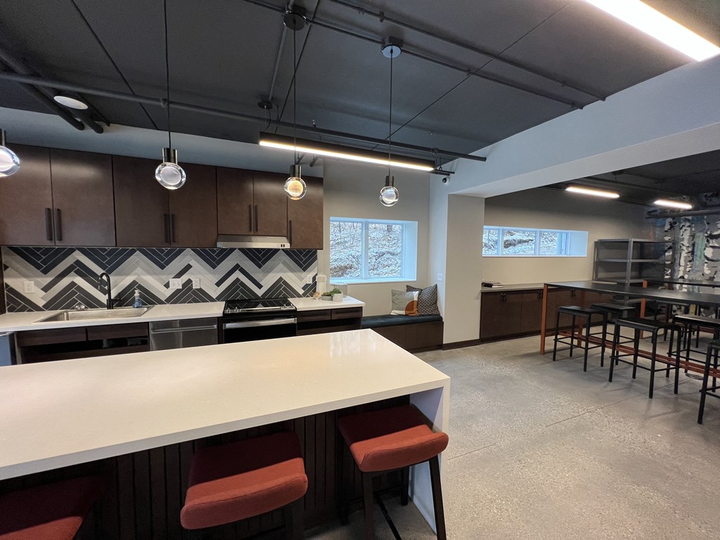a view of a kitchen and dining room in a workplace
