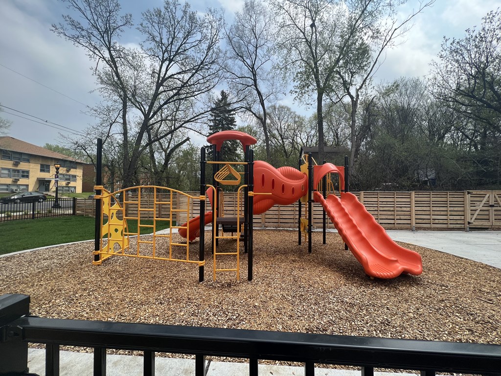 a playground with a slide and other toys in a park