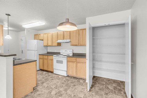 A kitchen with wooden cabinets and a white refrigerator.