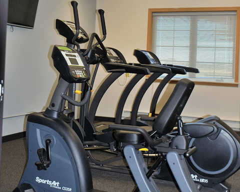 A SportsArt exercise bike is in a room with a window.