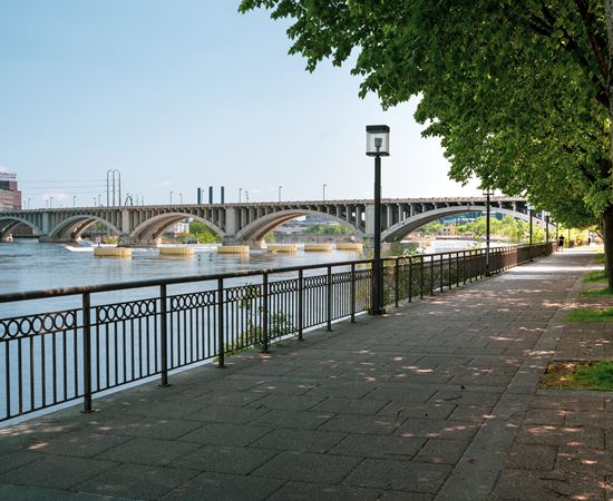 A bridge over a river with a walkway on the side.