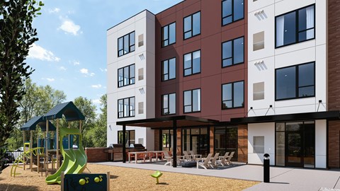 A modern apartment building with a playground in front.