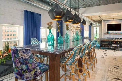 A dining room with a long table and chairs.