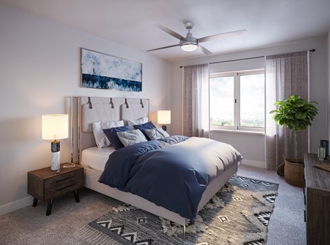 A bedroom with a large bed and a ceiling fan.