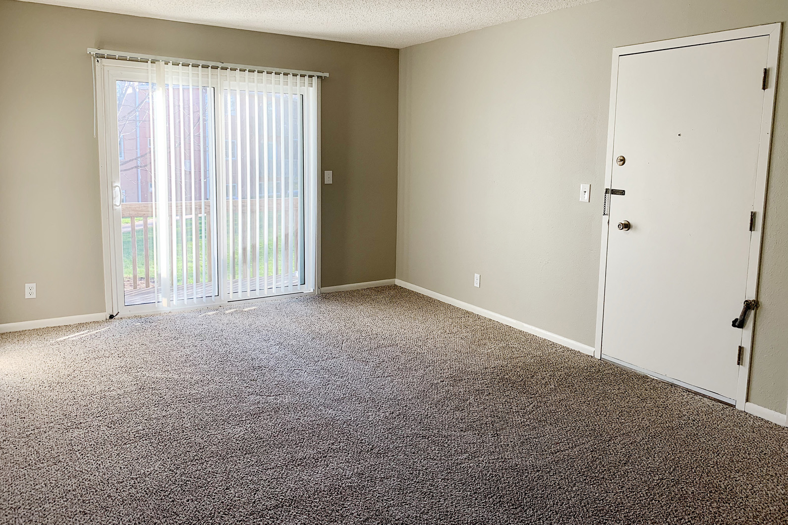 an empty room with a door and a window